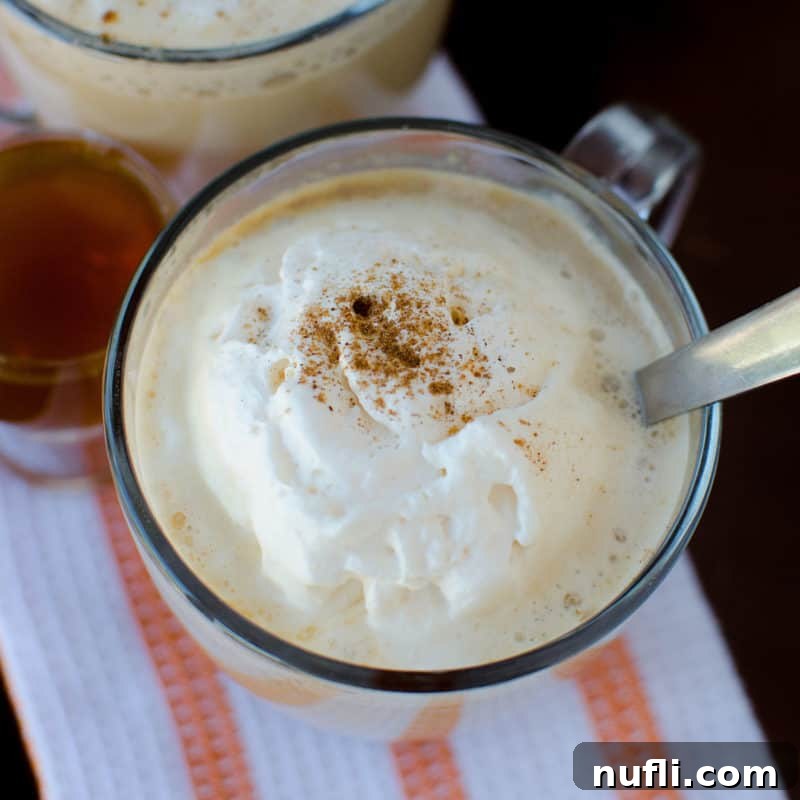 Crockpot Pumpkin Spice Latte in a glass mug with a silver spoon