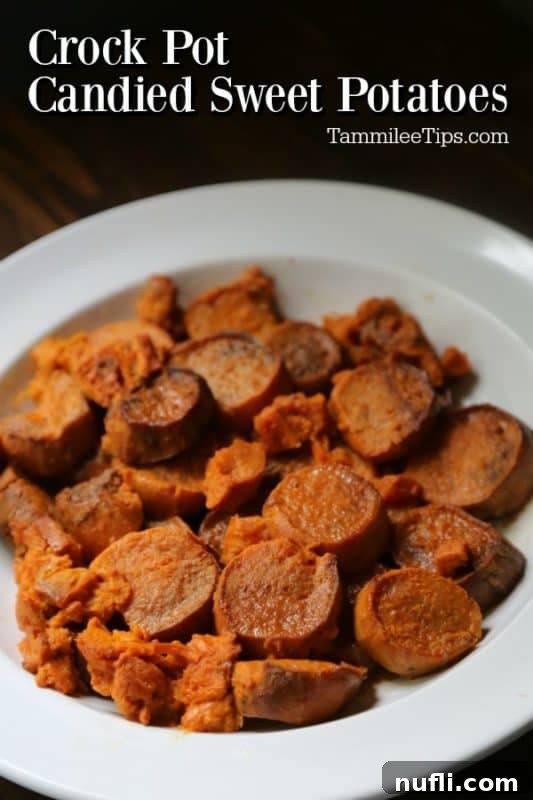 Golden Glazed Slow Cooker Sweet Potatoes 2 Close-up of golden, caramelized slow cooker candied sweet potatoes in a serving bowl, garnished with a sprig of fresh mint, ready for a holiday feast.