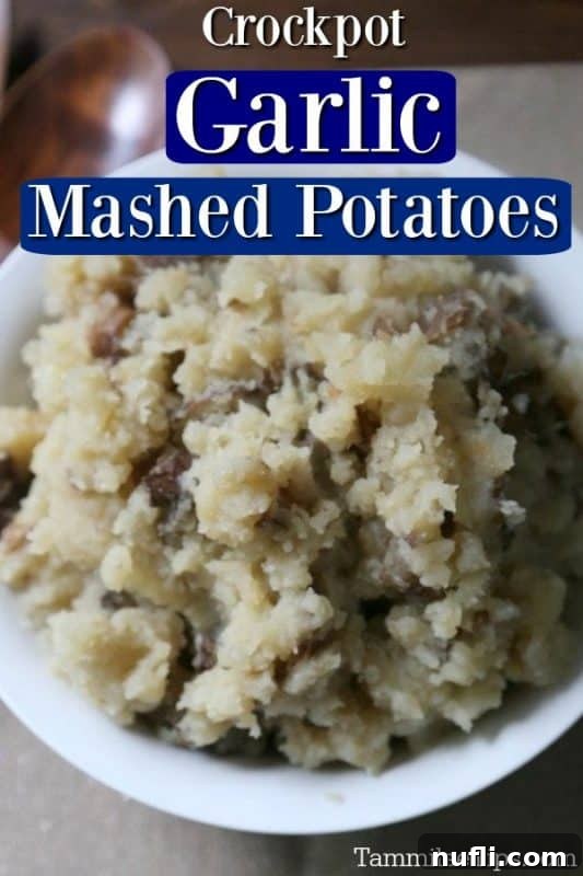 Creamy Crock Pot Garlic Mashed Potatoes in a white bowl, with a warm, inviting glow, perfect for holiday meals or family dinners.