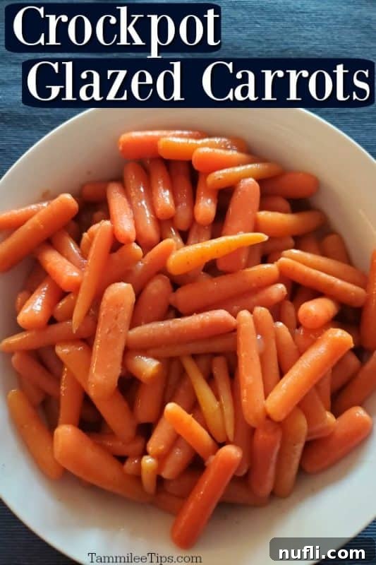 Crockpot glazed carrots in a white bowl on a blue tablecloth, ready to serve.