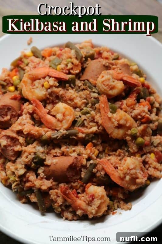 Hearty Crock Pot Kielbasa and Shrimp Stew served over rice in a white bowl, garnished with fresh herbs, showcasing the rich colors of the ingredients.