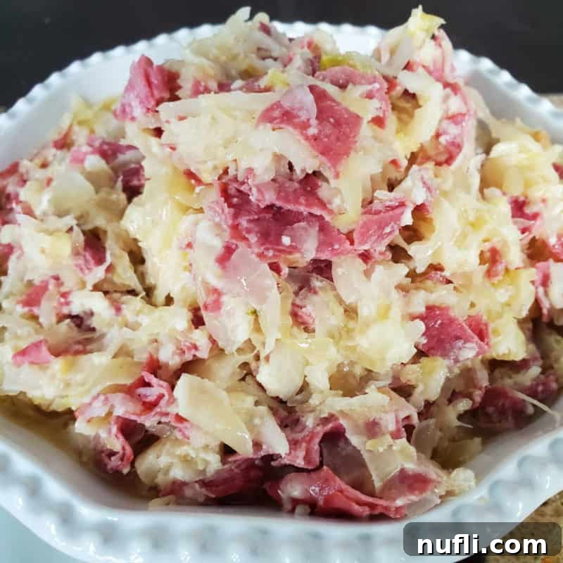 Easy Slow Cooker Appetizers 3 Classic Reuben Dip with Corned Beef in a White Bowl