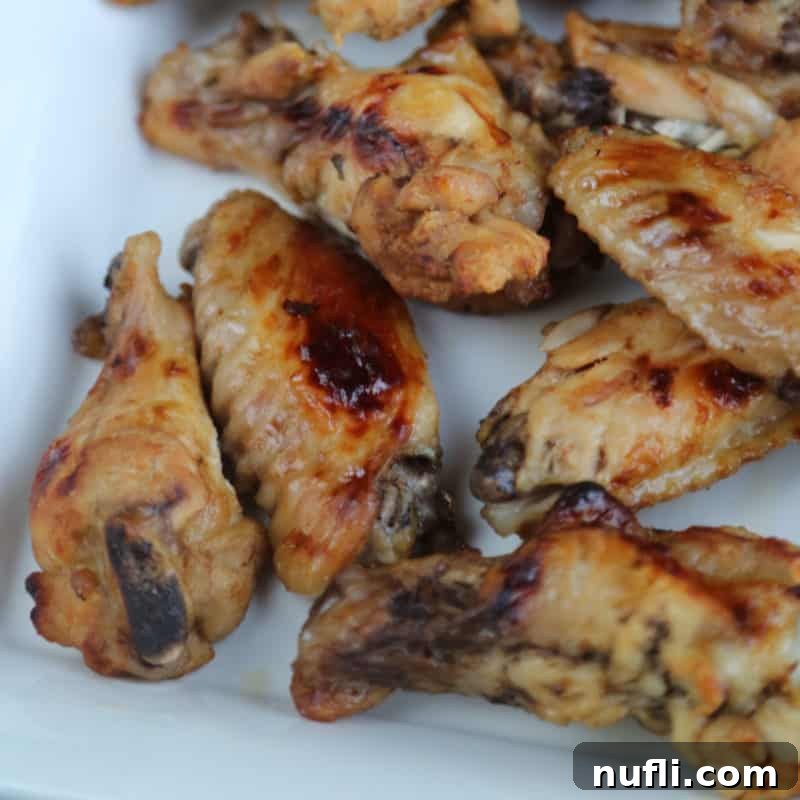 Easy Slow Cooker Appetizers 26 Mango Jerk Chicken Wings on a white platter, beautifully presented