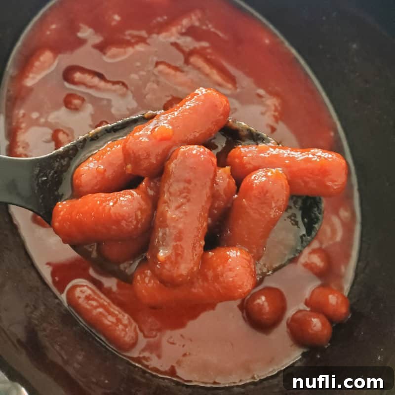 Easy Slow Cooker Appetizers 4 Crock Pot Bourbon Little Smokies being served from a slow cooker