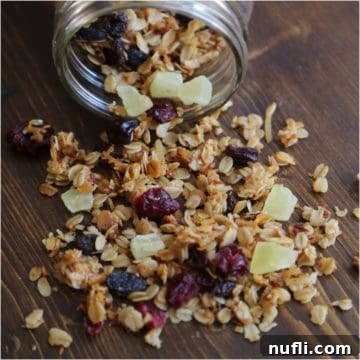Homemade Crockpot Granola with Sweet Dried Fruit 5 Crockpot granola with dried fruit pouring out of a mason jar