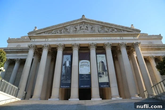 Archives of the United States of America buiding with signs hanging from the front 