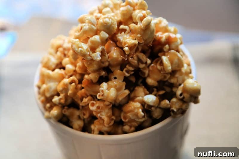 Caramel popcorn in a white popcorn bucket