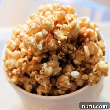 Salted Caramel Popcorn in a white popcorn tub