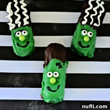 Three delightful Frankenstein Twinkies displayed on striped paper, ready for Halloween festivities.