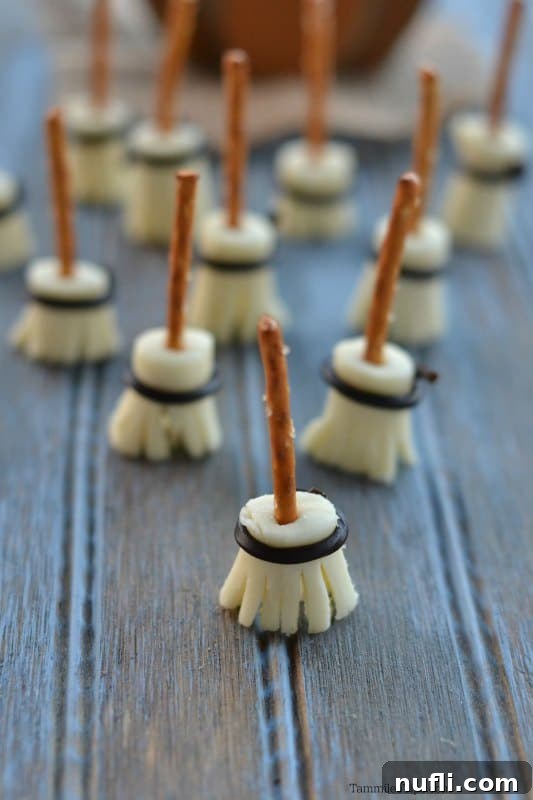 Close-up of a single Witches Broom Pretzel Stick, showcasing the pretzel handle and string cheese broom