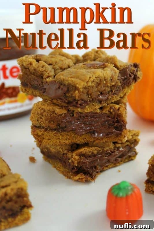 Stacked Pumpkin Nutella Bars with a small pumpkin beside them, evoking autumn vibes.