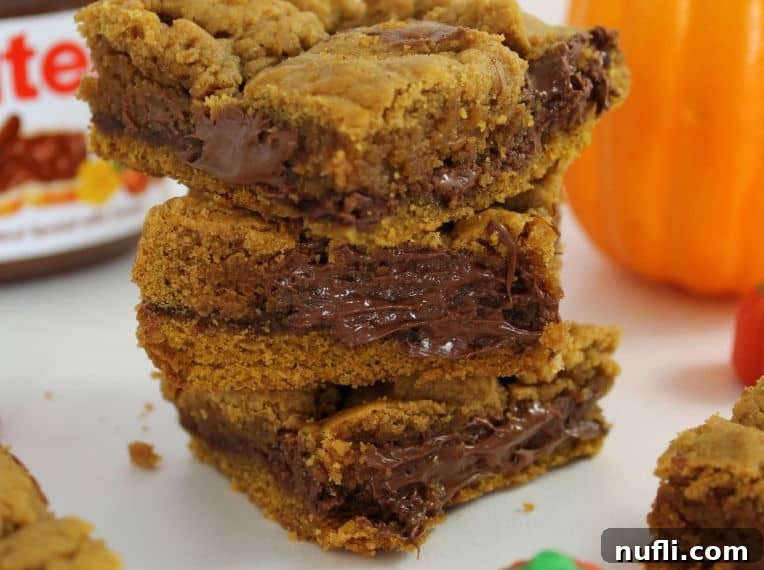 Close-up of stacked Pumpkin Nutella Bars showing the gooey Nutella layer.