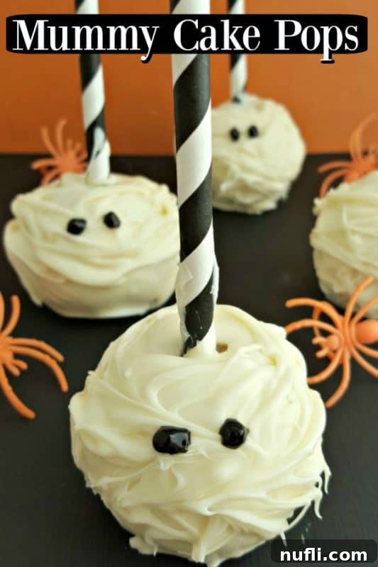 Two decorated Mummy Cake Pops with black and white striped sticks, ready for Halloween festivities.