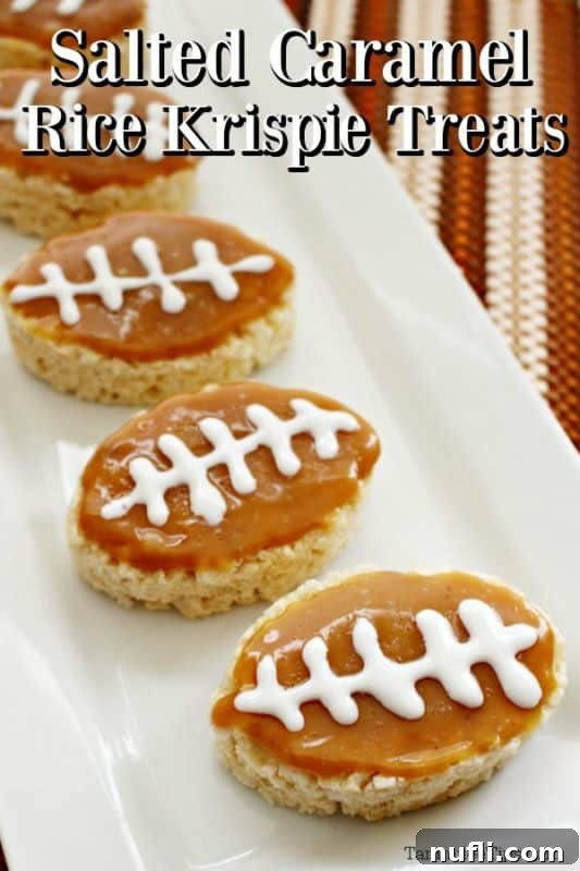 Salted Caramel Rice Krispie Treats arranged on a white platter, shaped like footballs and drizzled with caramel and white icing laces.