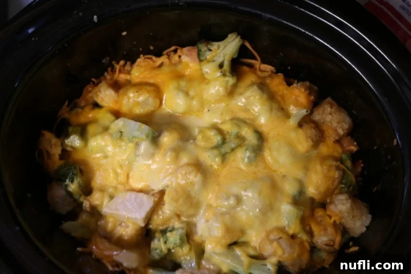 tater tot chicken casserole in a dark slow cooker