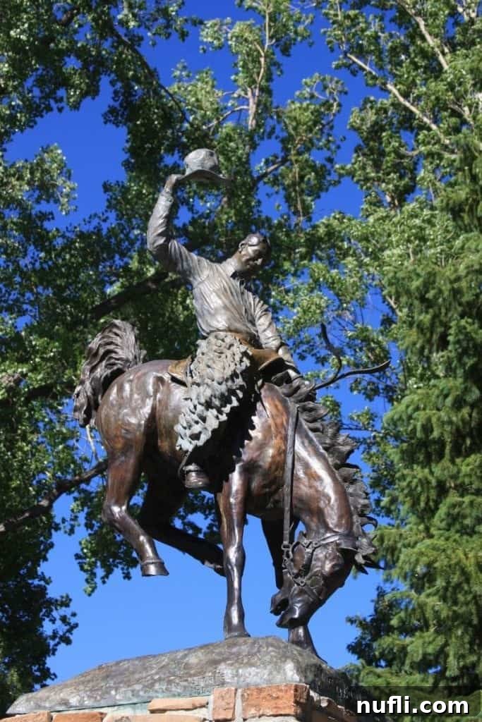 Iconic cowboy statue on a bucking horse in Jackson Hole, representing the spirit of the American West.