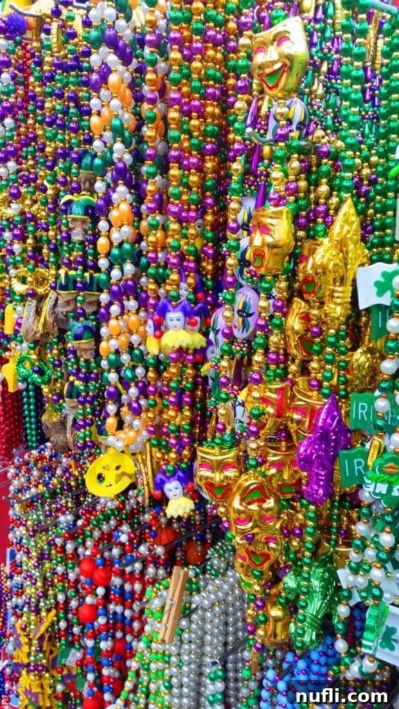 Strings of colorful Mardi Gras beads for sale, a common sight in the festive New Orleans French Quarter.