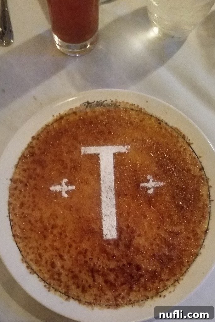 An exquisite Crème Brûlée dessert, perfectly caramelized, served at Tableau New Orleans restaurant.