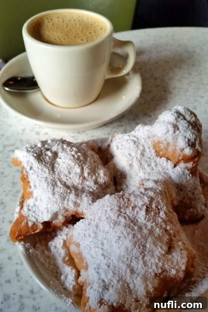 The iconic Cafe du Monde, a renowned spot for beignets and coffee in New Orleans, bustling with activity.