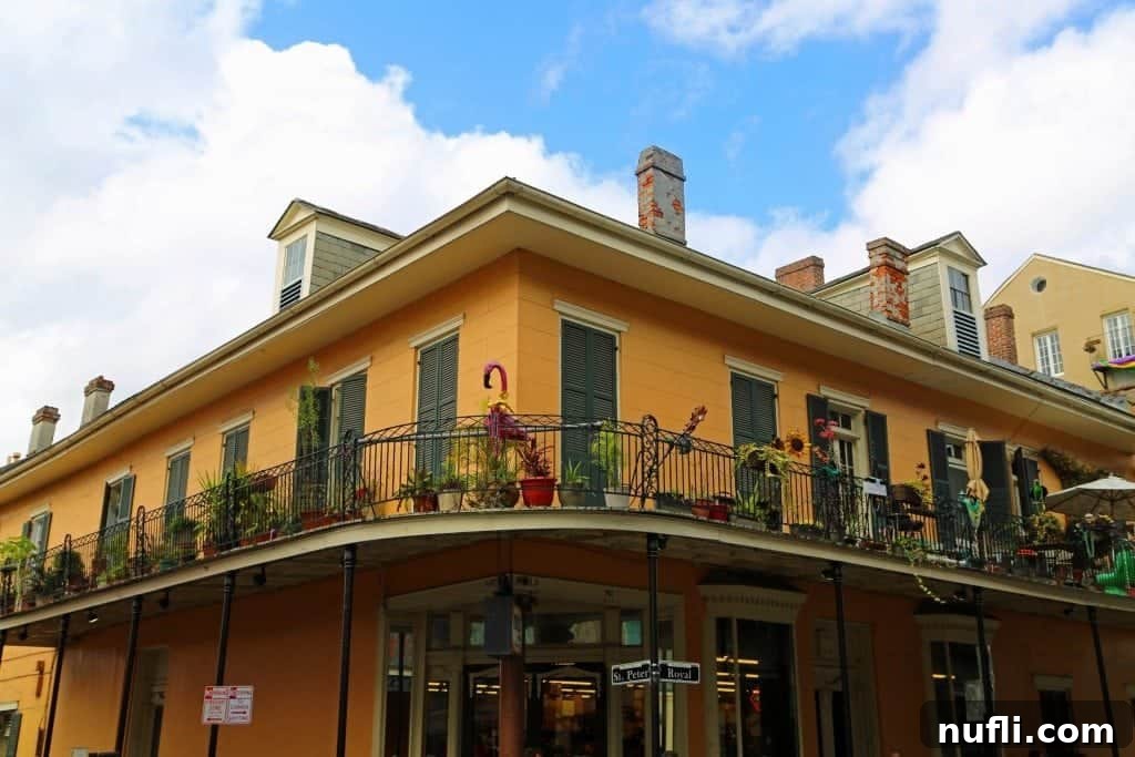 A vibrantly colored building showcasing the distinct architectural style of the New Orleans French Quarter.