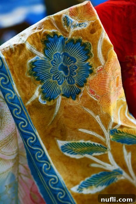 Vibrant purple flower pattern on a piece of Balinese batik fabric, showcasing the rich colors and designs