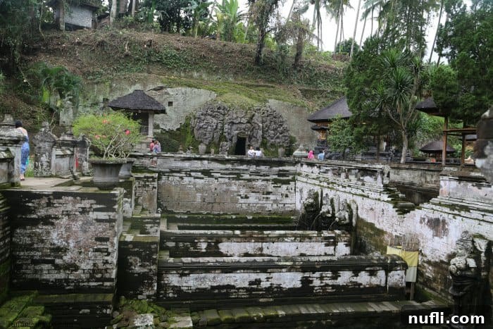 Bali's Ancient Goa Gajah Elephant Cave 3 Baths and Elephant Cave entrance with people walking around