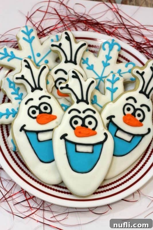 Irresistibly Cute Olaf Cookies 2 Beautifully decorated Olaf cookies on a white plate, ready to be enjoyed.