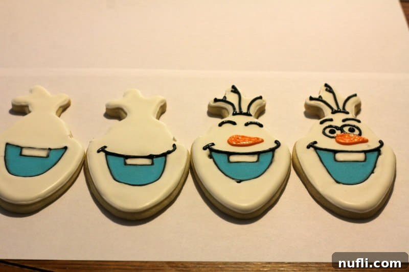 Irresistibly Cute Olaf Cookies 4 Multiple Olaf cookies in various stages of decoration, showcasing the creative process.