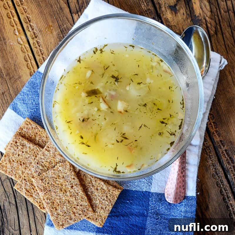 Crockpot Cabbage Roll Soup in a glass bowl next to crackers and a spoon