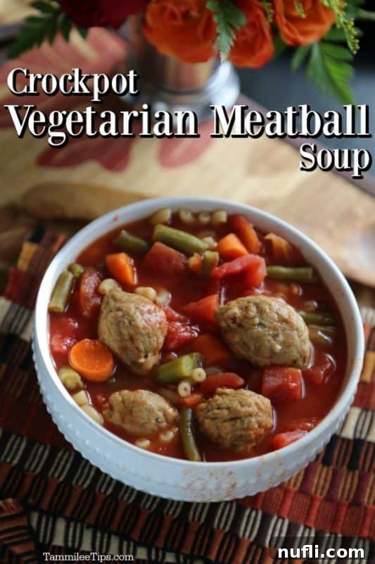 Hearty Crockpot Vegetarian Meatball Soup served in a white bowl, garnished with fresh herbs.