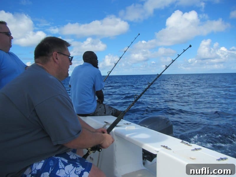 Grand Turk Deep Sea Fishing: Hooking Adventure, Landing Joy 6 John holding a fishing pole
