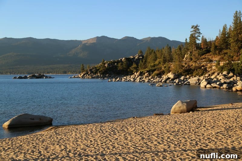 Beach at Lake Tahoe with mountains behind it