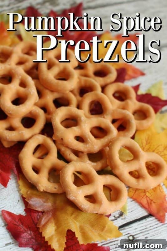 Pumpkin Spice Pretzels text written over a pile of pumpkin spice pretzels on a wood background