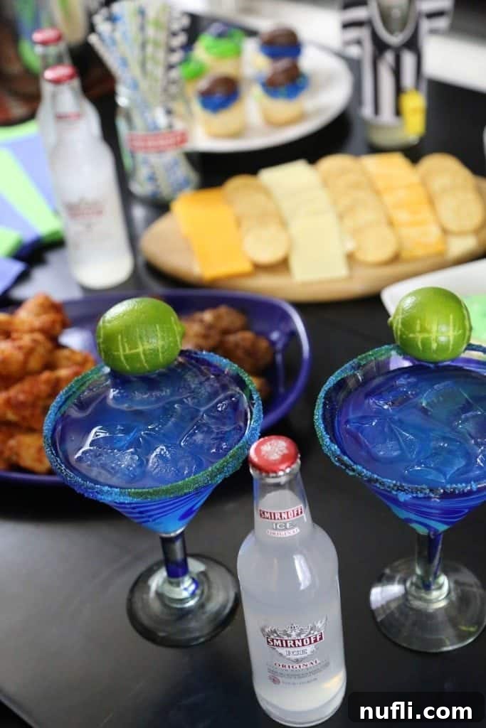 Two glasses of Hawk-Arita Cocktail, garnished with lime, ready for a Seattle Football game day party