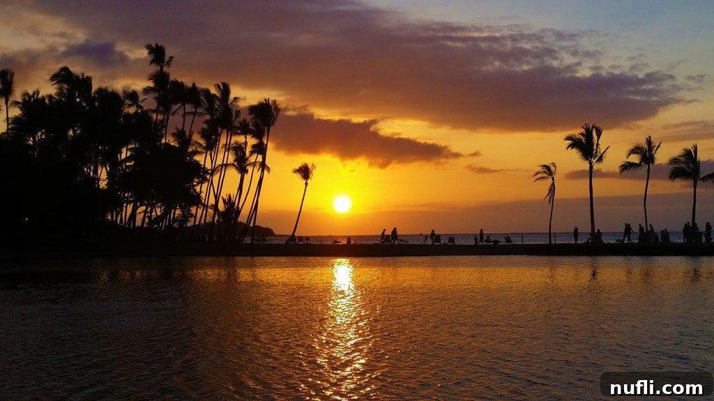 Breathtaking sunset at Anaehoomalu Bay (A-Bay) in Kona, Hawaii, with calm waters and reflections