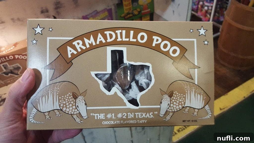 A playful 'Armadillo Poo' novelty item in a Grapevine shop window, showcasing local Texas humor.