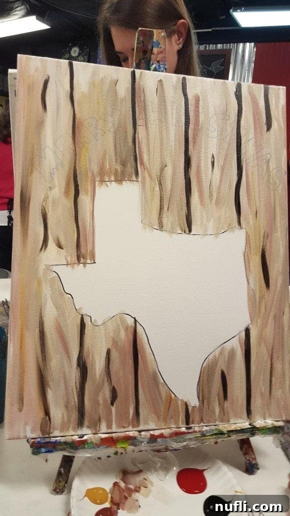 A student concentrating on their painting during a fun art class experience.