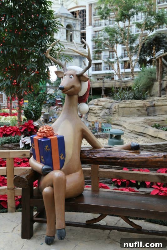 Christmas at the Gaylord Texan in Grapevine, Texas 6 reindeer sitting on a bench holding a package wrapped in Gaylord Texan wrapping paper