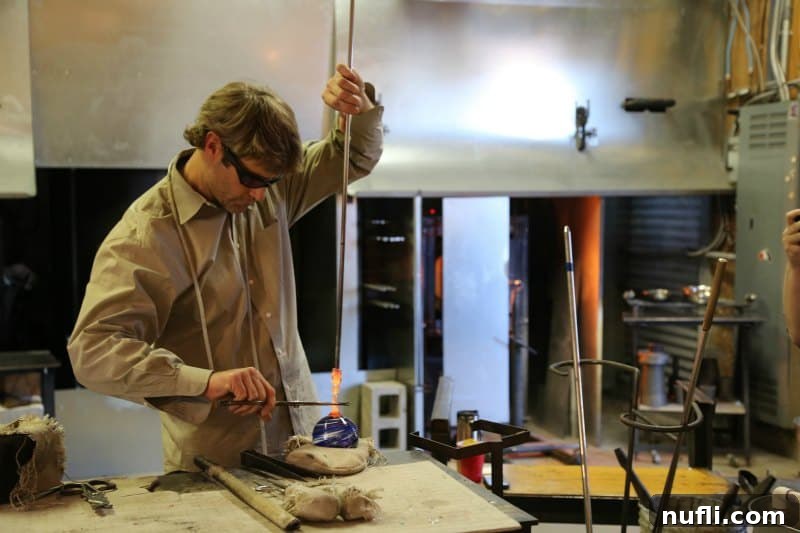 Glass worker working on a glass ball 