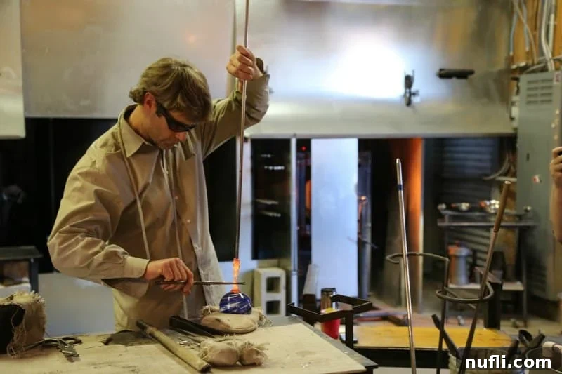 Glass worker working on a glass ball 