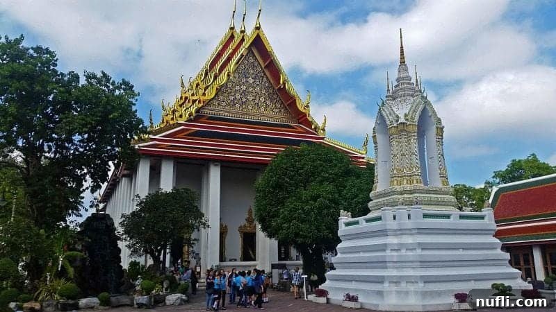 A beautifully decorated temple structure with intricate details, vibrant colors, and traditional Thai motifs at Wat Pho.