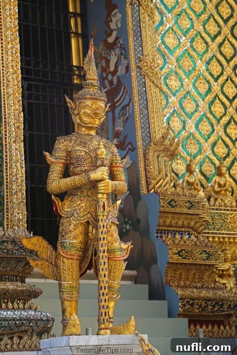 Bangkok's Grand Palace: Discovering Royal Thailand with Essential Visitor Tips 3 Golden statue at the Grand Palace in Bangkok, gleaming under the sun