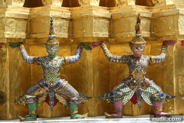 Bangkok's Grand Palace: Discovering Royal Thailand with Essential Visitor Tips 6 Two figurines designed to look like they are holding up a portion of the building in the Grand Palace
