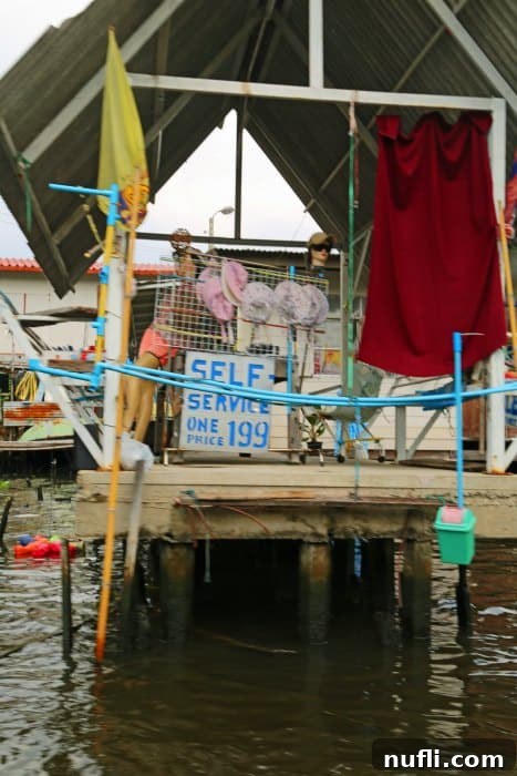 A self-service convenience store built along the edge of the Chao Phraya River, accessible by boat