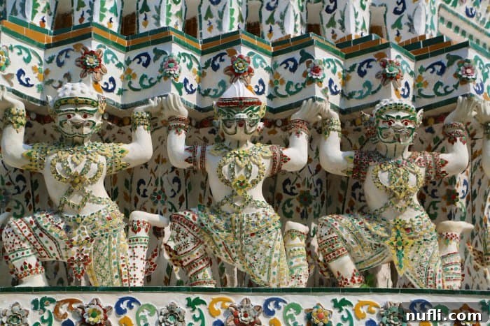 Bangkok Chao Phraya River Cruise 10 Close-up of the intricate mosaic decoration on a pagoda (prang) at Wat Arun, the Temple of Dawn, featuring colorful porcelain pieces and detailed craftsmanship.