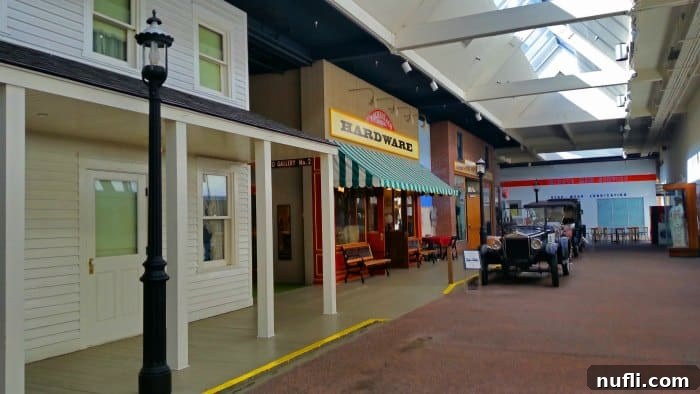 Replica old school street with classic cars and vintage storefronts