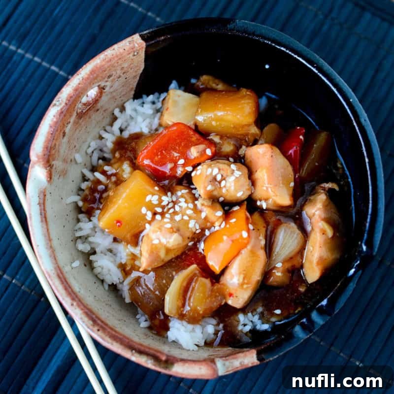Savory Crockpot Teriyaki Chicken, served in a bowl with chopsticks, ready for a delightful Asian-inspired meal.