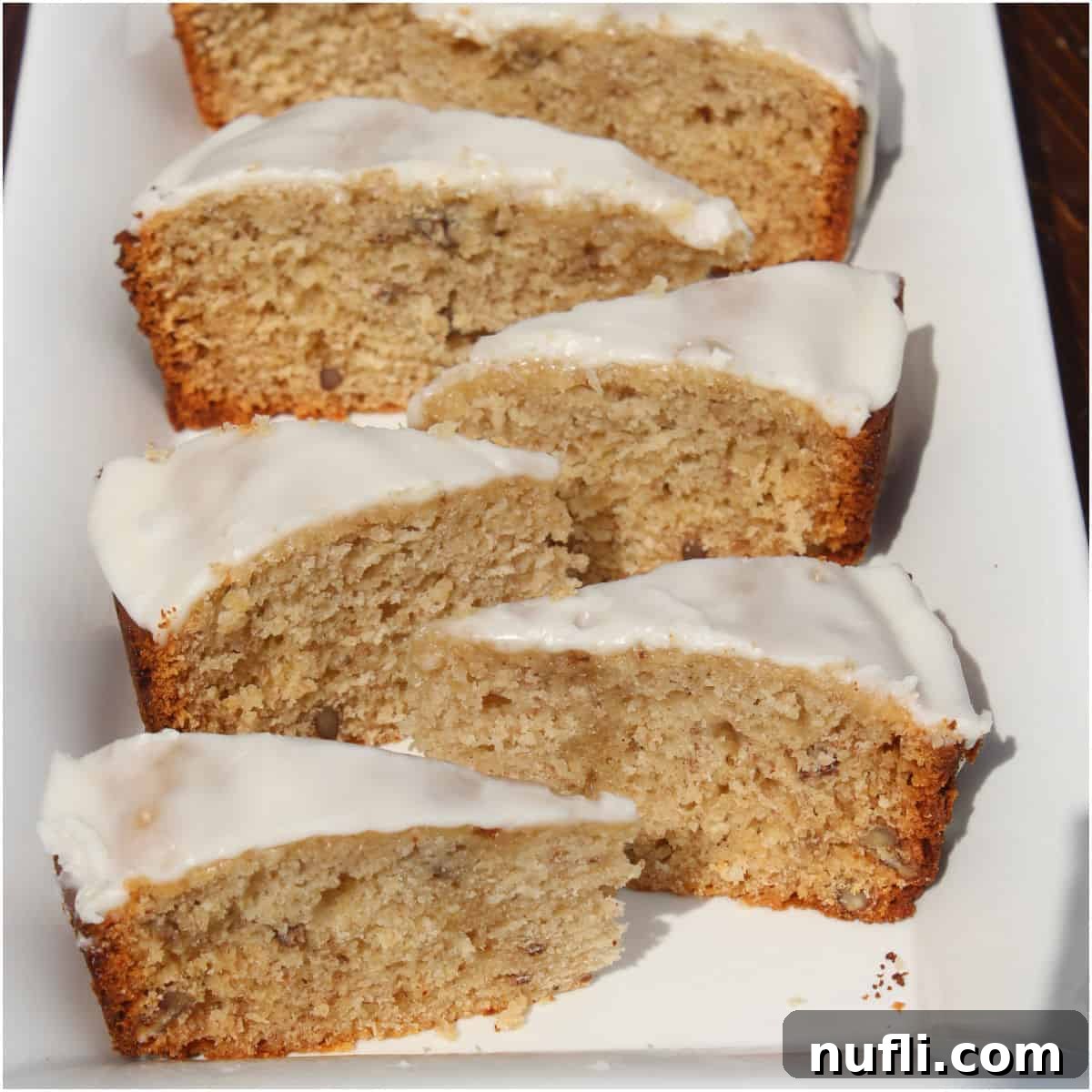 Over 40 Simple Plant-Based Slow Cooker Meals 39 Slices of bourbon banana bread on a white platter, a rich and moist loaf