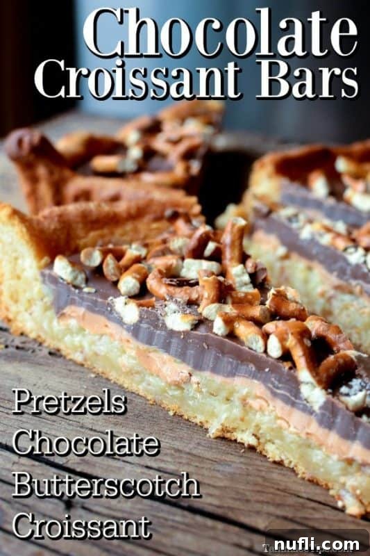 Sweet and Salty Chocolate Dessert Bar topped with pretzel on a wood board, showcasing its rich layers and crunchy topping.