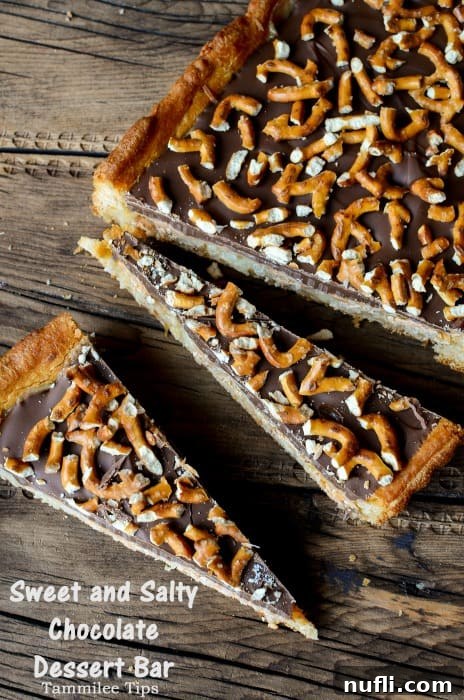 Close-up of a large portion of sweet and salty chocolate dessert bars, with a few triangular pieces cut and ready to serve, highlighting the distinct layers of chocolate, butterscotch, coconut, and pretzel topping.